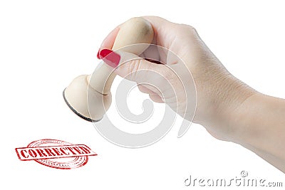 Hand holding a rubber stamp with the word corrected Stock Photo