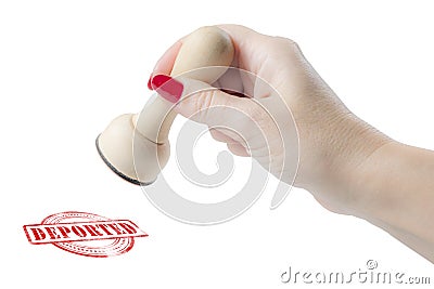 Hand holding a rubber stamp with the word deported Stock Photo