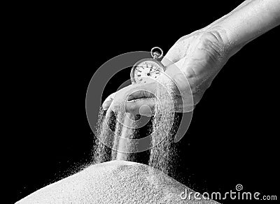 Hand holding sand and clock Stock Photo