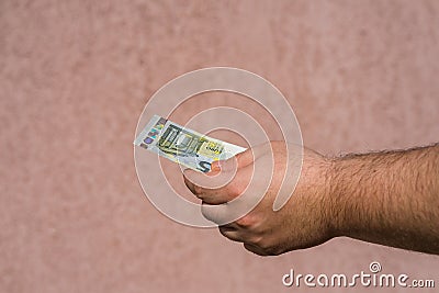 Hand holding showing euro money and giving or receiving money like tips salary. 5 EURO banknotes EUR currency isolated. Concept Stock Photo