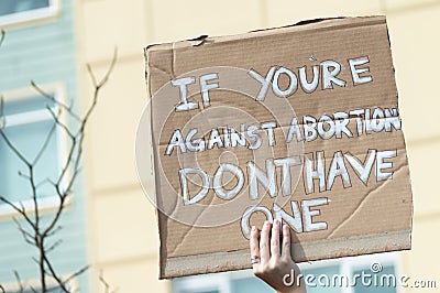 A hand holding a sign supporting pro-choice during a rally for abortion justice. Stock Photo