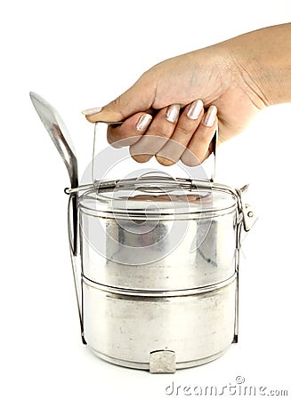 A hand holding silver metal tiffin Stock Photo