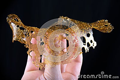 Hand holding a slab of concentrated cannabis oil extraction aka Stock Photo