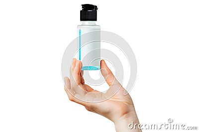 Hand holding small bottle with blue sanitizing liquid Stock Photo
