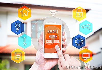 Hand holding smart phone with home control application with blur Stock Photo