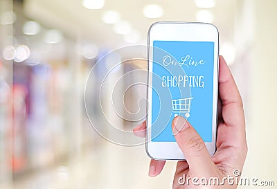 Hand holding smart phone with online shopping device on screen o Stock Photo