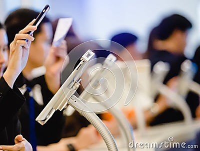 Hand holding smart phone and scan QR code over tablet for registration in to seminar Stock Photo