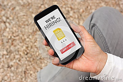 Hand holding smartphone with we are hiring apply now concept on Stock Photo