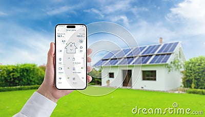 Hand holding smartphone with smart home app, monitoring solar panel energy, temperature, and home consumption Stock Photo