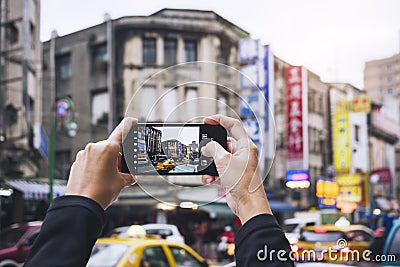 Hand holding Smartphone Take photo Old building city street Taipei tourist spot Editorial Stock Photo