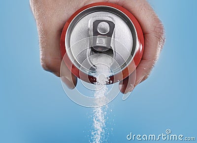 Hand holding soda can pouring a crazy amount of sugar in metaphor of sugar content of a refresh drink Stock Photo