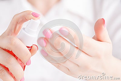 Hand holding spay bottle Stock Photo