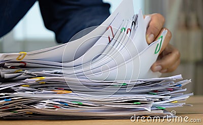 Hand holding of Stack of Group report papers Document clipped in color clips, business, and education concept Stock Photo