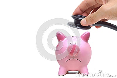 Holding stethoscope over a sad piggy bank Stock Photo