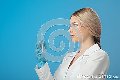 Woman`s hand holding syringe and medicine vial prepare for injection in operating room. Space for text Stock Photo