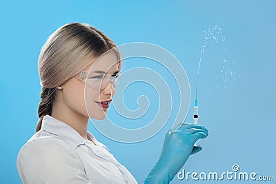 Woman`s hand holding syringe and medicine vial prepare for injection in operating room. Space for text Stock Photo