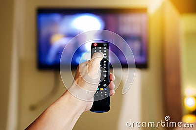 Hand holding television and audio multimedia remote control for watching tv Stock Photo
