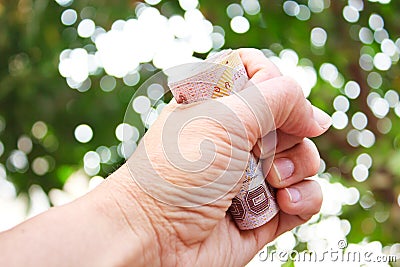 Hand holding thai money. Stock Photo