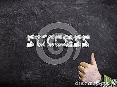 Success Written On A Chalkboard With Thumbs Up Sign Stock Photo