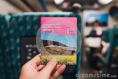Hand holding a ticket of Taiwan High Speed Train on platform in Taiwan, Taipei Editorial Stock Photo