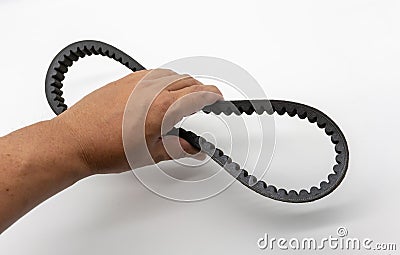 Hand holding the timing belt for motorcycle engine white background Stock Photo