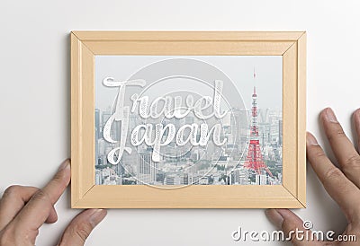 Hand holding travel japan Tokyo poster photo frame Stock Photo