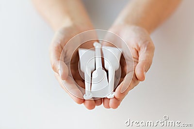 Hand holding tubes of micro enema Stock Photo