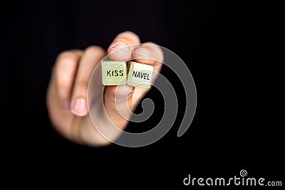 Hand holding two dice with erotic text for sexual game on dark black background with copy space, sex,love,adult,games concept Stock Photo