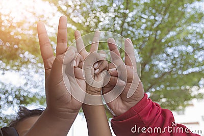 Hand holding up the peace sign Stock Photo