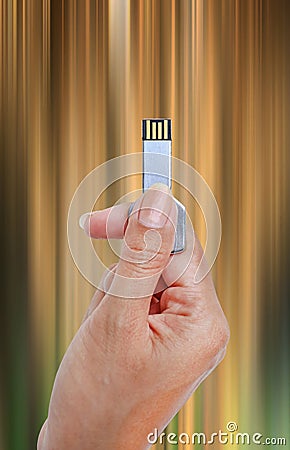Hand holding USB data storage against light and circuit Stock Photo