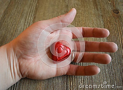 Woman`s hand holding a candy heart Stock Photo