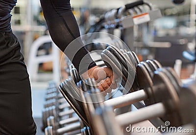 Hand holding weight dumbbell in gym close up arm muscle exercise with dumbbell. Stock Photo