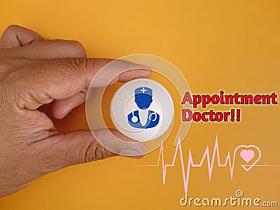 Hand holding white ball with doctor icon, heart beat icon and text Appointment doctor on background Stock Photo