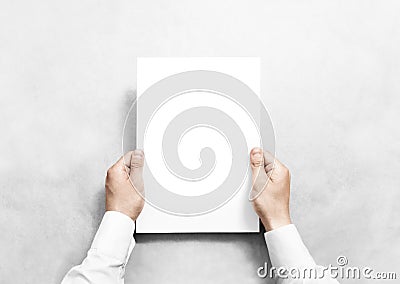 Hand holding white blank paper sheet mockup, . Stock Photo