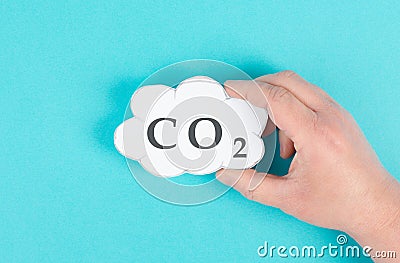 Hand holds cloud with the word CO 2, carbon dioxide emission, environmental issue, air pollution Stock Photo