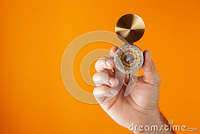 hand holds compass Stock Photo