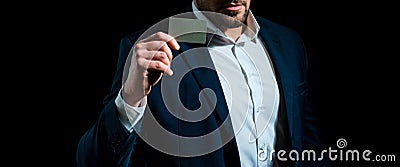 Hand holds a credit card. Business man paying online with creditcard. Stock Photo