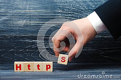 Hand holds a cube with the letter S with the word http. Changing the protocol for security and transfer of hypervistext, increasin Stock Photo
