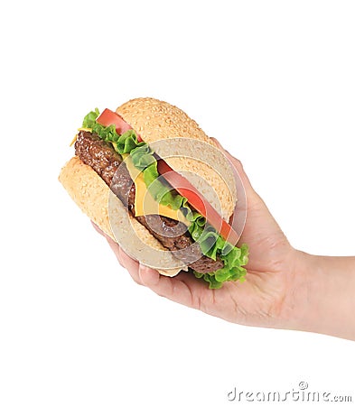 Hand holds fresh hamburger. Stock Photo