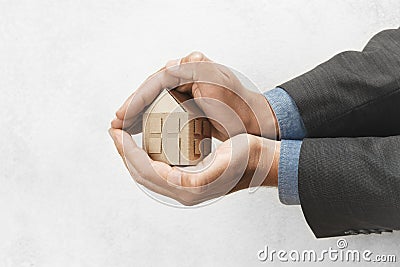 Hand holds house. Buying or selling home, real estate insurance. Protection and safety life Stock Photo