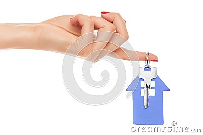 Hand holds key with a keychain the shape of house. Stock Photo