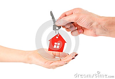 The hand holds the keys with the red house keychain. Purchase of Stock Photo