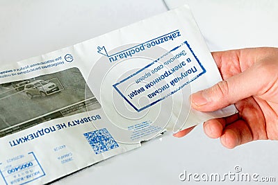 a hand holds a letter with notification of traffic violations. Editorial Stock Photo