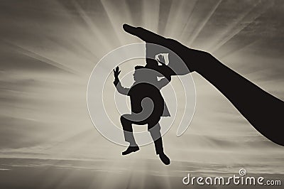 Hand holds man by collar in air Stock Photo
