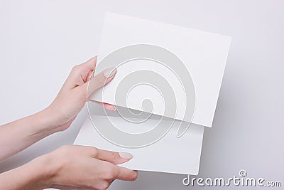 Hand holds A5 paper for presentation or design insert Stock Photo