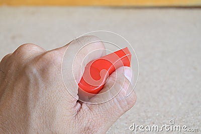 Hand holds a red whistle Stock Photo