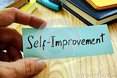 Hand holds sign Self improvement Stock Photo