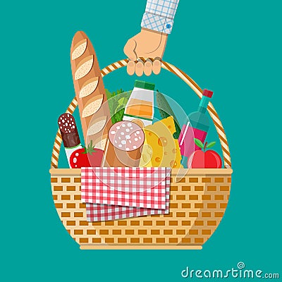 Hand holds wIcker picnic basket full of products. Vector Illustration