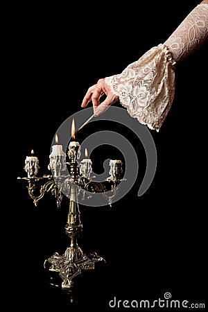 Hand igniting candles Stock Photo