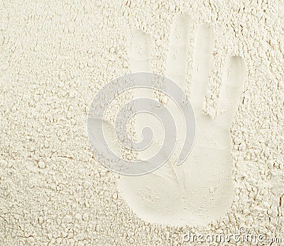Hand imprint over wheat flour Stock Photo